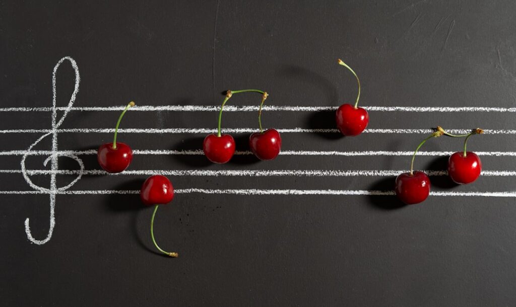 black board with sheet music and cherries.