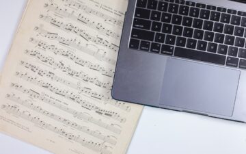 laptop sitting on sheet music